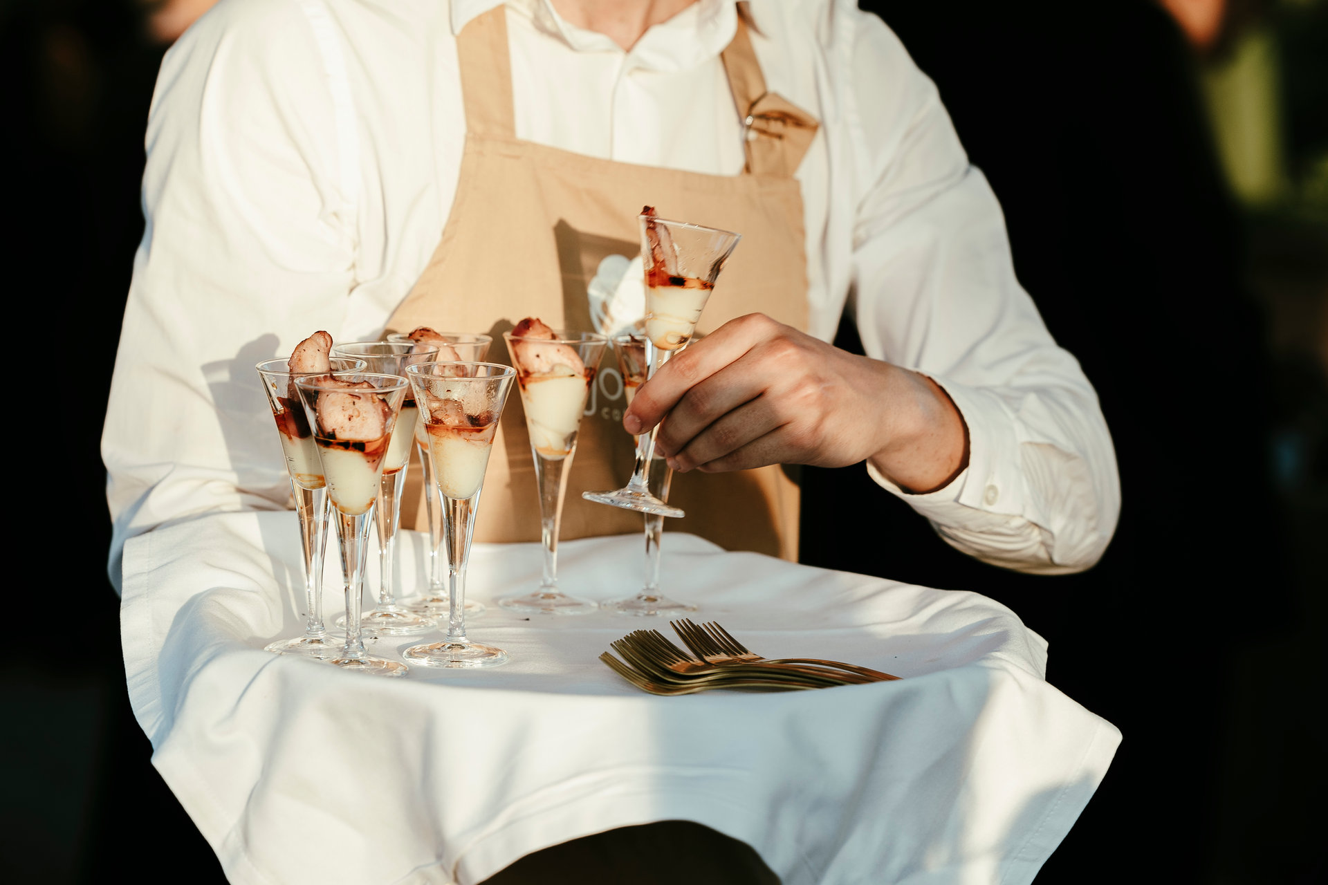 Waiter serving cocktail appetisers